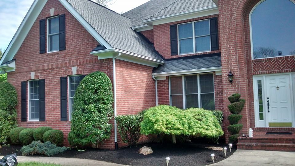 Trimmed topiary and freshly cleaned garden beds ahead of a Green Diamond spring cleanup in Baltimore County, MD