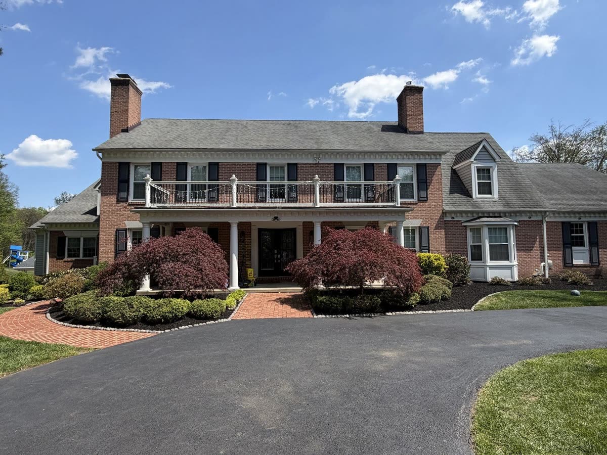 Fresh mulch beds installed around a colonial home in Reisterstown, MD